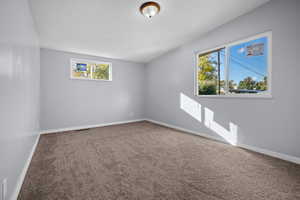 Carpeted empty room featuring baseboards
