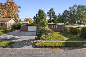 Single story home featuring a front lawn and concrete driveway