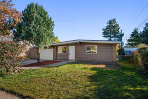 Ranch-style home featuring brick siding, concrete driveway, and a garage