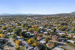 Aerial view of property's location featuring a mountainous background and nearby suburban area