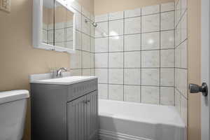 Bathroom featuring vanity and washtub / shower combination