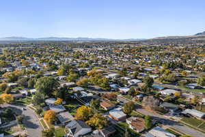 Aerial overview of property's location featuring a mountain backdrop and nearby suburban area