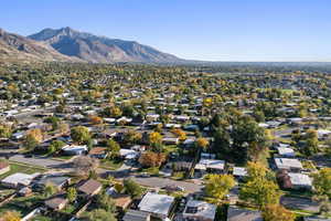 Aerial overview of property's location featuring a mountain backdrop and nearby suburban area