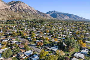 Aerial view of property's location featuring a mountainous background and nearby suburban area