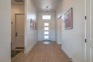 Entryway featuring baseboards and concrete flooring