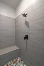 Bathroom featuring a tile shower