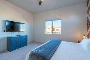 Bedroom featuring light colored carpet and ceiling fan