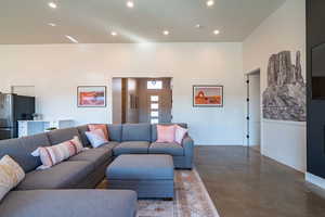 Living area featuring concrete flooring and recessed lighting