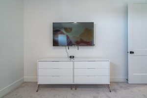 Bedroom featuring light colored carpet