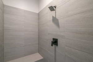 Full bath featuring tiled shower
