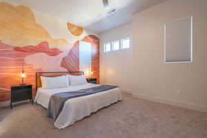 Bedroom with carpet flooring and an accent wall