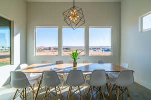 Dining area featuring finished concrete floors and a chandelier