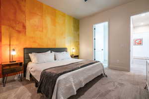 Carpeted bedroom featuring baseboards