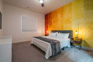 Bedroom with dark colored carpet and a ceiling fan
