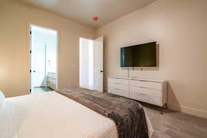 Bedroom with carpet floors and ensuite bathroom