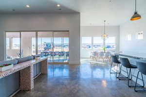 Living room featuring finished concrete floors and recessed lighting