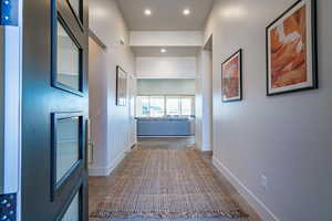 Corridor featuring concrete flooring and recessed lighting
