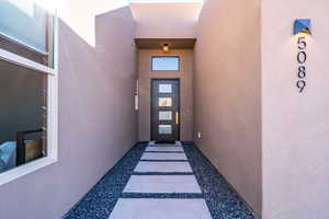 View of exterior entry with stucco siding