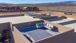 View of pool with a patio, an outdoor living space, and a mountain view