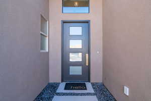 Property entrance featuring stucco siding
