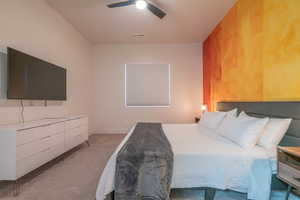 Bedroom featuring light carpet and ceiling fan