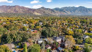 Aerial view of property's location featuring a mountainous background and nearby suburban area