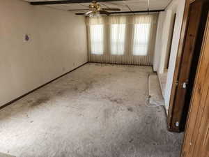 Empty room with a ceiling fan and plenty of natural light