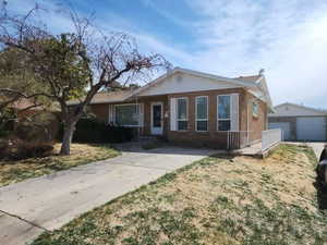 Ranch-style house with an outbuilding and brick siding