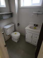 Half bathroom featuring healthy amount of natural light and vanity