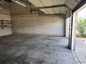 Garage with concrete block wall and a garage door opener