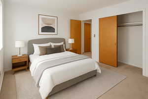 Bedroom featuring light carpet and a closet