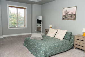 Carpeted bedroom featuring baseboards