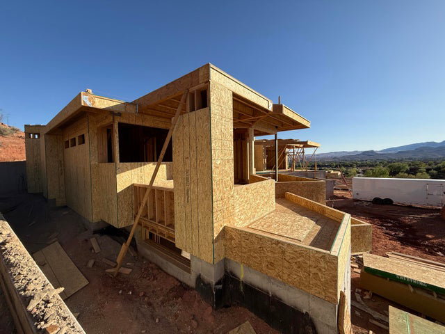 View of property exterior featuring a mountain view and an outbuilding