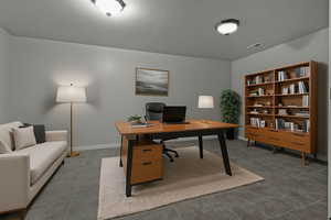 Home office featuring tile patterned flooring and baseboards