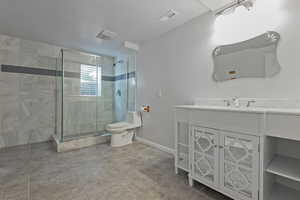 Bathroom featuring vanity, a shower stall, and light tile patterned flooring
