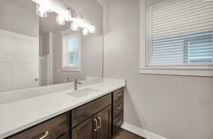 Bathroom with vanity and dark wood-type flooring