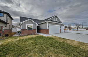 Single story home with brick siding, board and batten siding, driveway, an attached garage, and roof with shingles