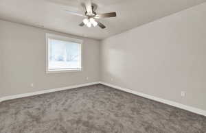 Unfurnished room featuring carpet and a ceiling fan