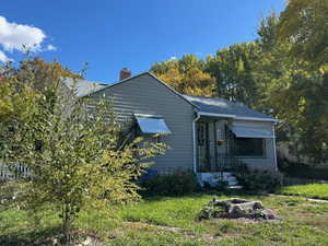 Bungalow featuring a chimney