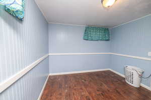 Unfurnished room with dark wood-style flooring and baseboards
