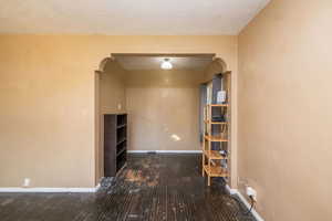 Corridor with arched walkways and a textured ceiling