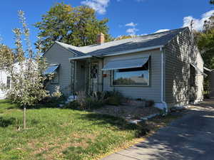 Bungalow-style house with a front yard and a chimney