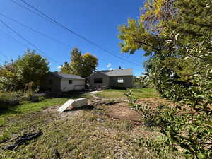 View of green lawn with a patio area