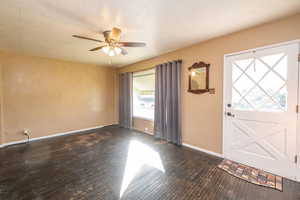 Foyer entrance featuring a ceiling fan and a textured ceiling