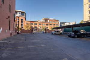 Code protected covered parking lot featuring a gate with an opener