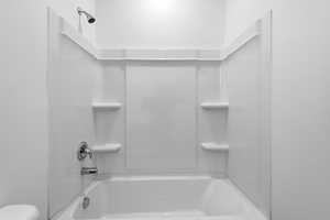 Full bathroom with shower / washtub combination and toilet
