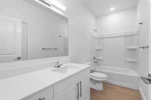 Full bathroom with vanity, light wood-style flooring, and tub / shower combination
