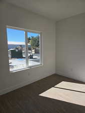 Club room with baseboards and dark wood-type flooring