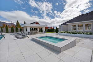 View of swimming pool with a pool, a patio area, and an in-ground hot tub