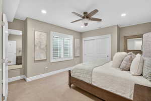 Carpeted bedroom featuring ceiling fan, recessed lighting, and a closet
